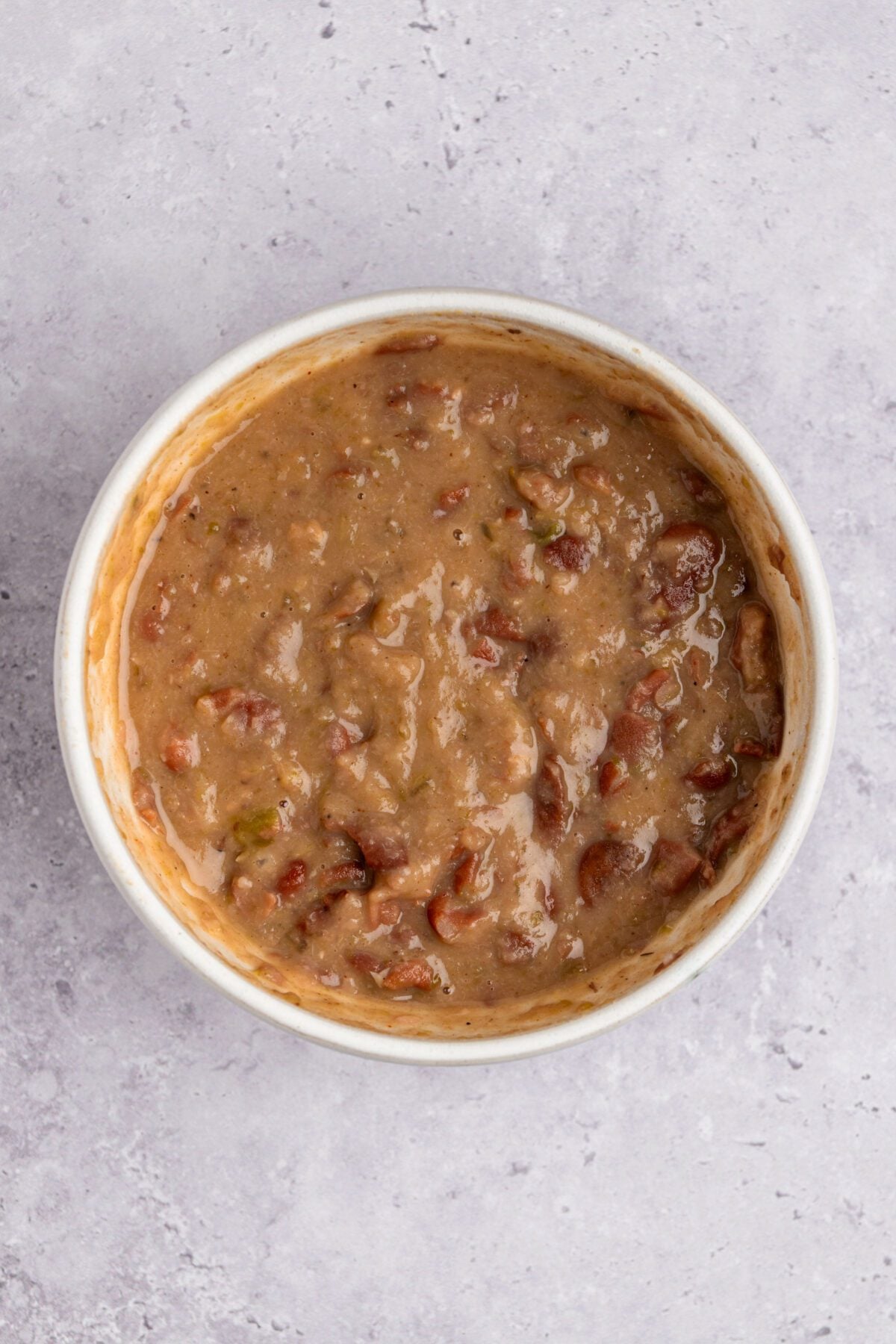 Dutch oven with mashed beans added back to mixture