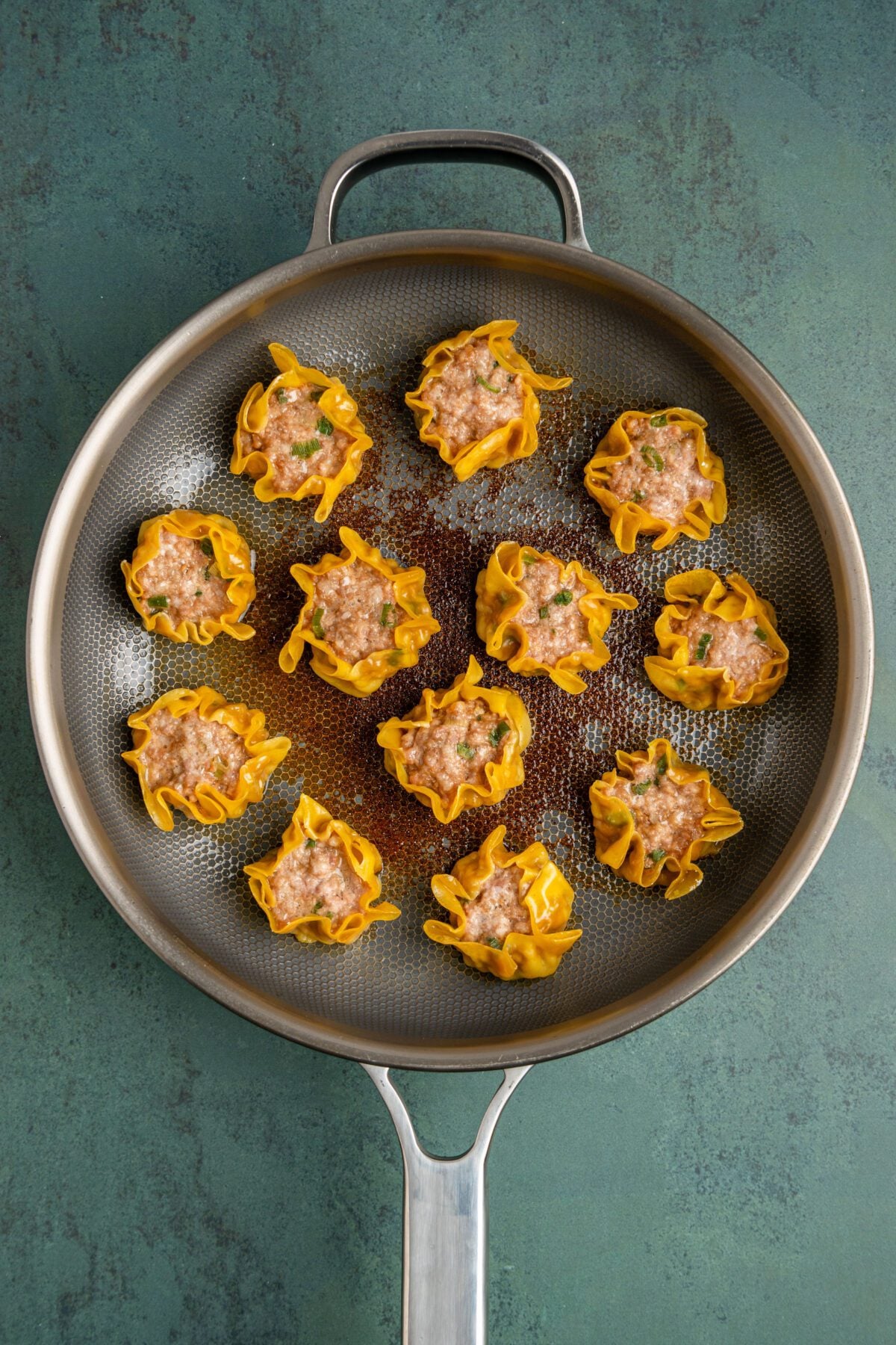 lightly crisp, golden dumplings with cooked pork interior 