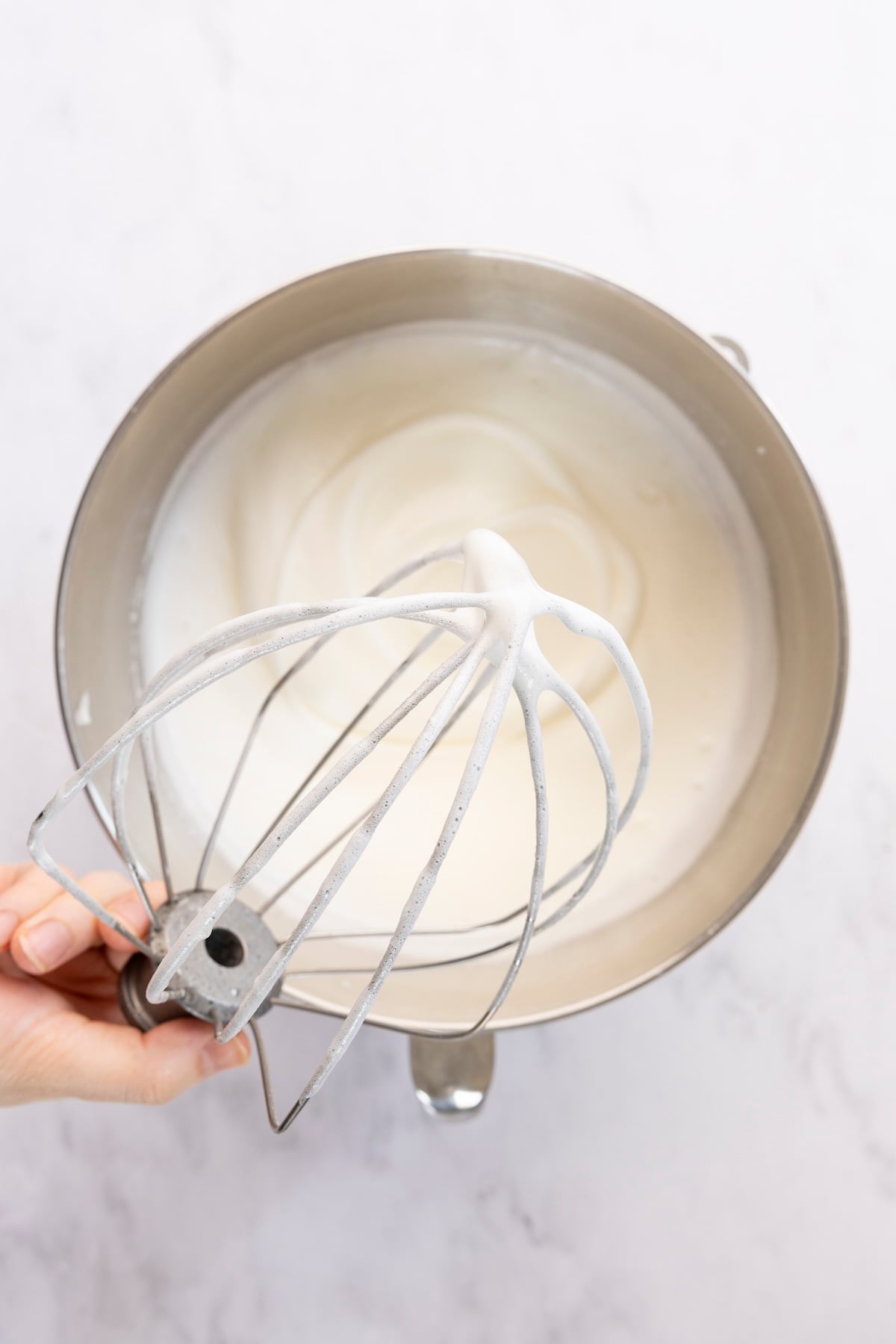 Whipped egg whites in mixing bowl