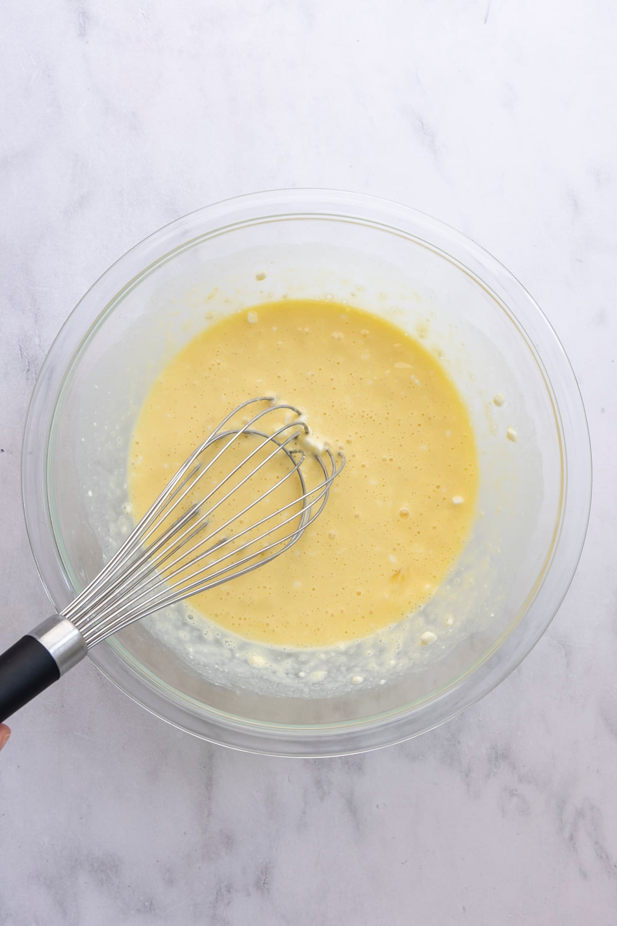 medium bowl with cottage cheese, milk, eggs, sugar, and vanilla whisked together