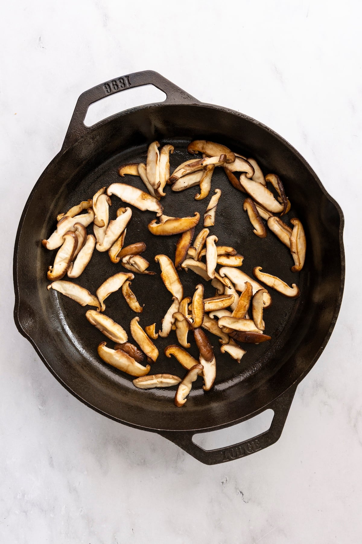 Cooked mushrooms in cast iron skillet.