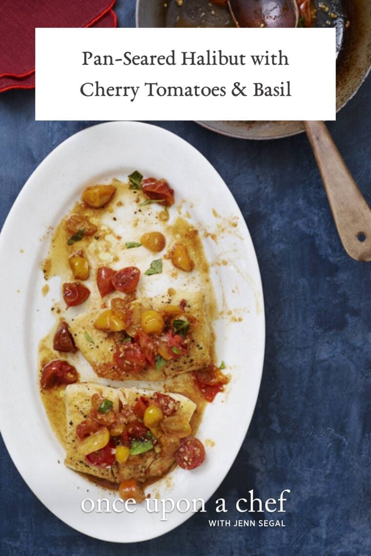 pan-seared halibut with cherry tomatoes and basil on white oval serving plate