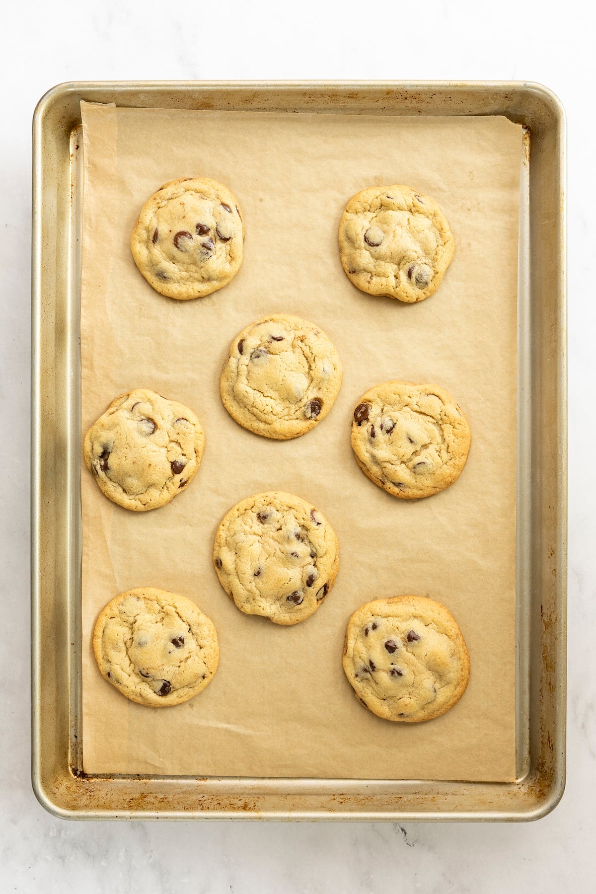 baked tahini chocolate chip cookies on parchment lined baking sheet