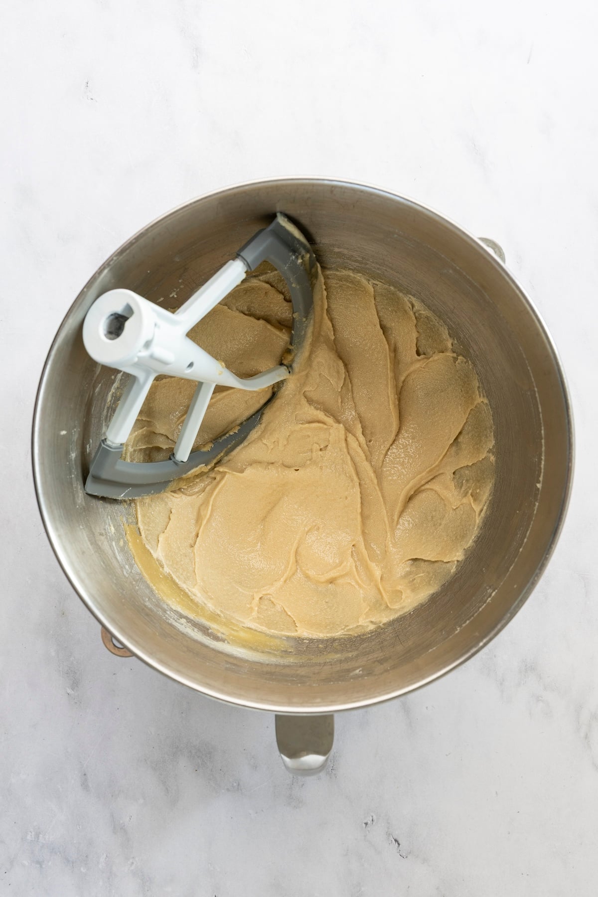 mixing bowl with butter, tahini, sesame oil, granulated sugar, and brown sugar mixed together