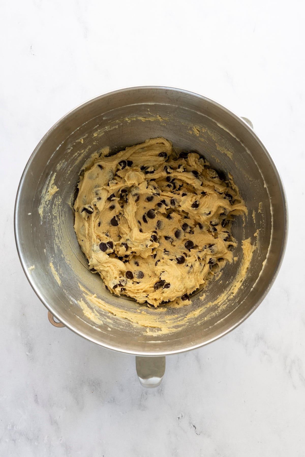 mixing bowl with chocolate chips combined with batter