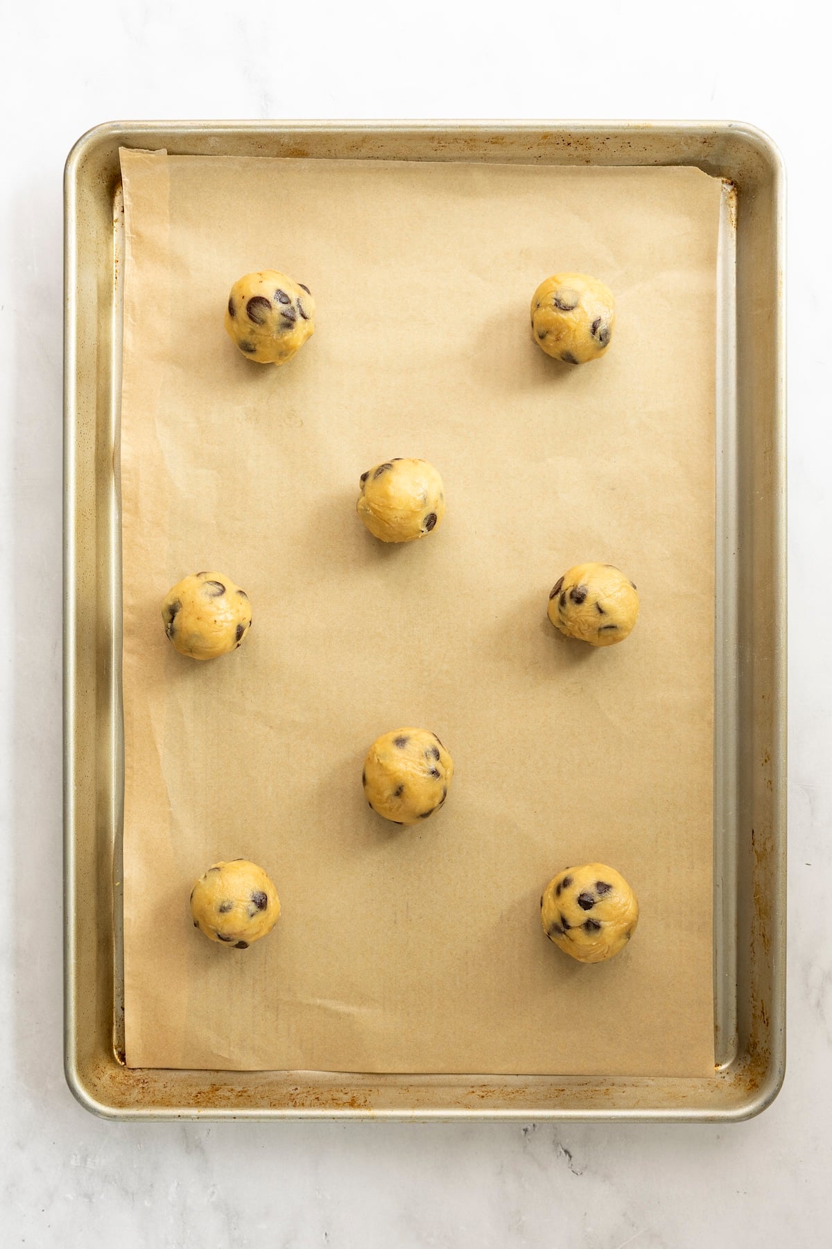 Tahini chocolate chip cookie dough scooped into balls.