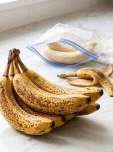 Ripe and peeled bananas on countertop for freezing.