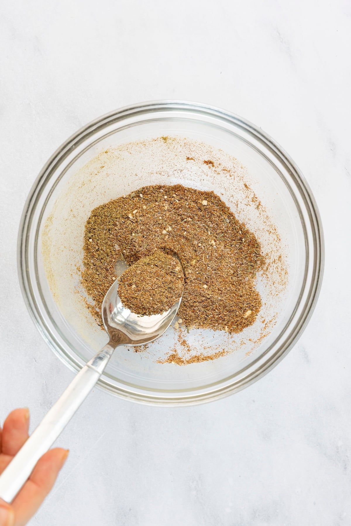 SMALL BOWL SALT, PAPRIKA, SAGE, THYME, BLACK PEPPER, GARLIC POWDER, AND ONION POWDER COMBINED TOGETHER