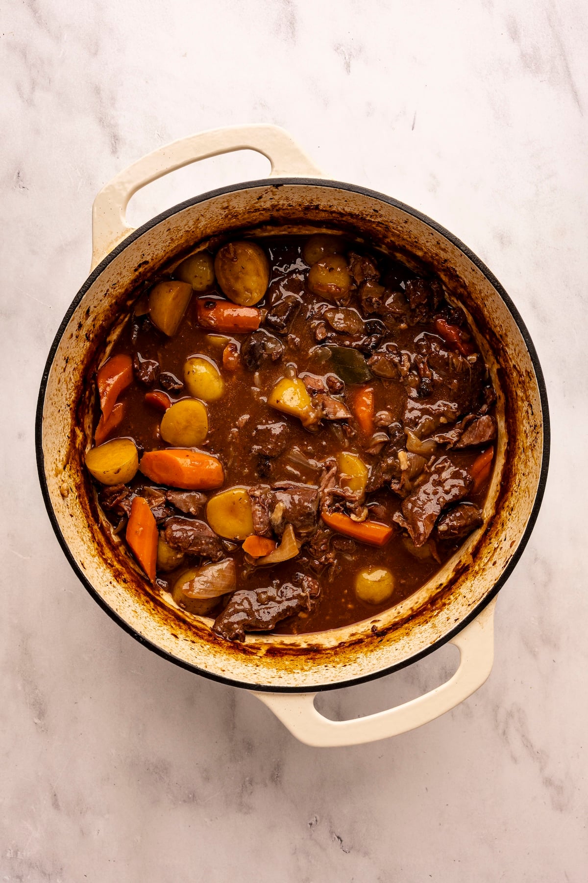 beef stew with carrots and potatoes in Dutch oven