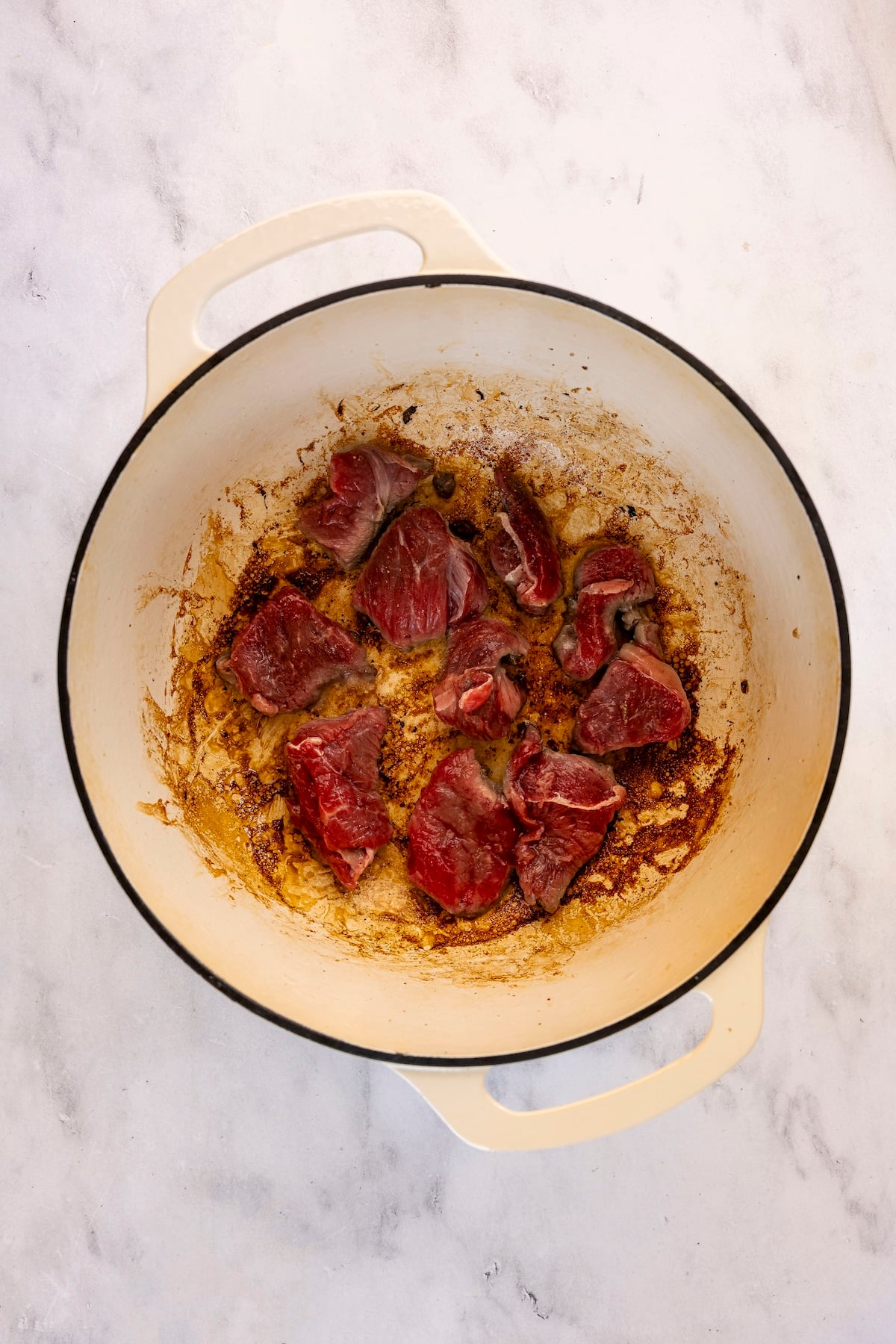 Searing beef in Dutch oven.
