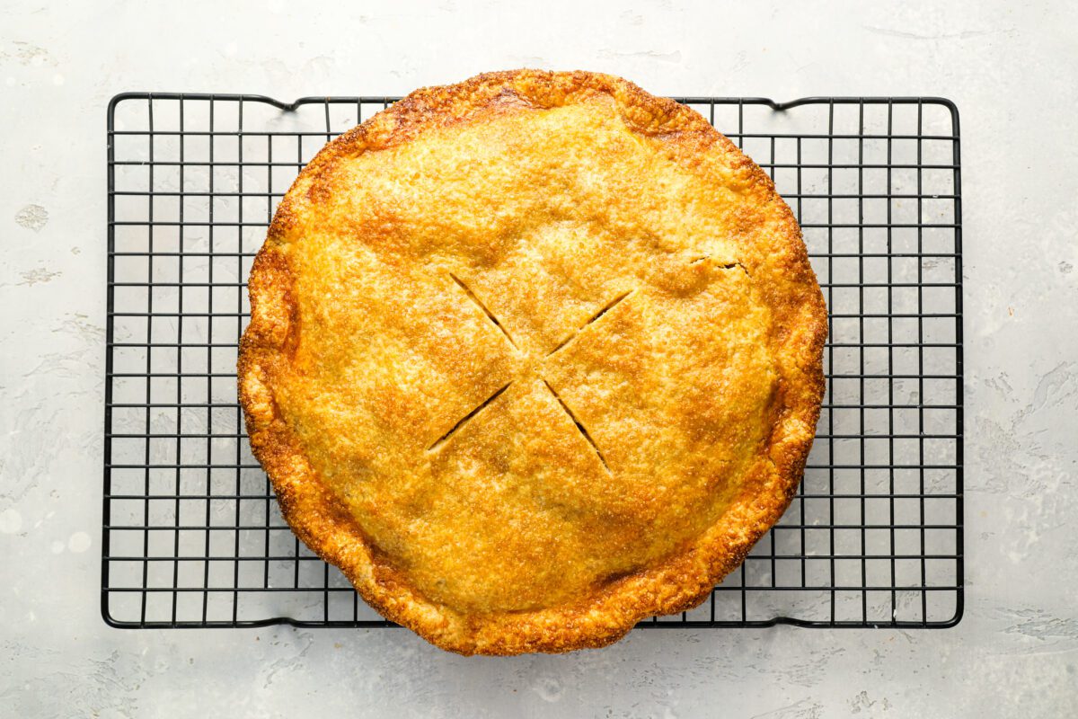 Apple pie cooling on rack.