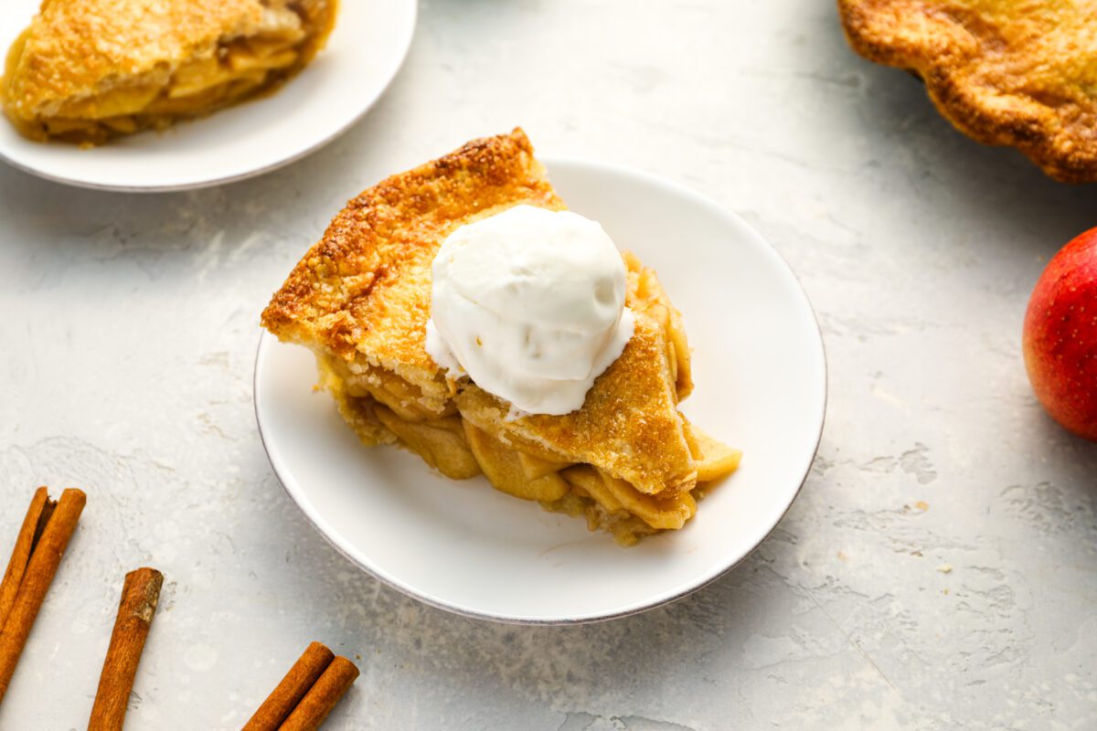 Slice of homemade apple pie with vanilla ice cream.