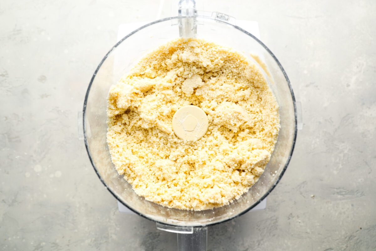 Crumbly pie dough in food processor.