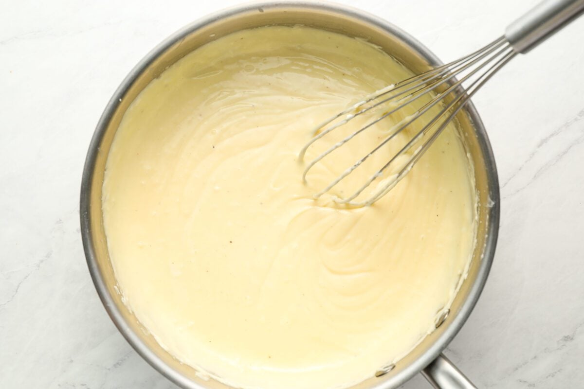 bechamel sauce with whisk in medium saucepan